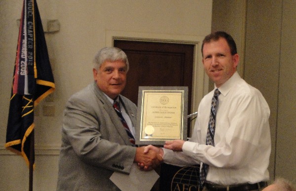 In July, Victor Budura (l), chapter president, presents John Roberts, Nextek, with an AFCEA Corporate Partner Certificate in recognition of his company.